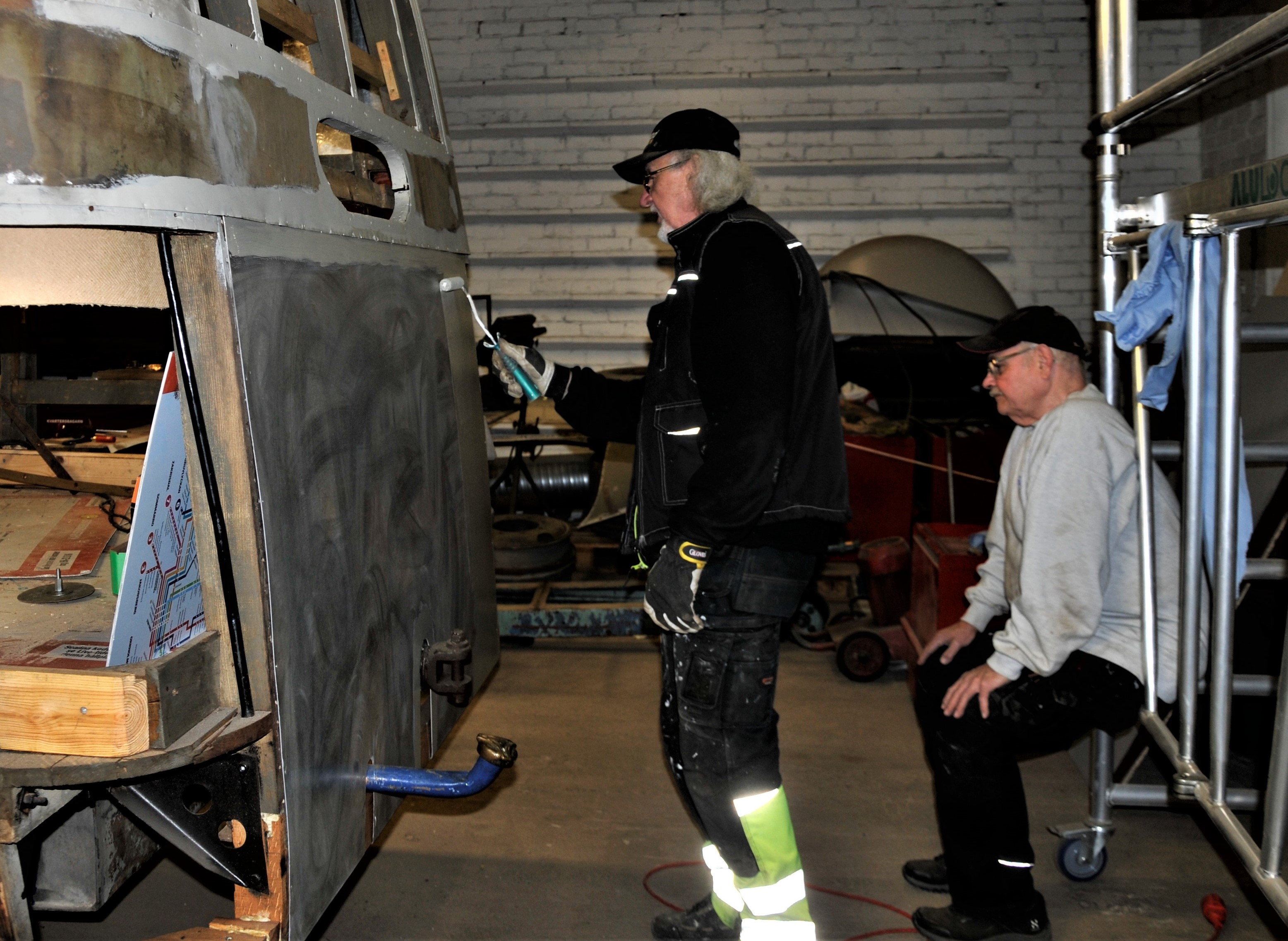 Lasse provar att få på färg med roller. Zärny övervakar arbetet Lasse provar att få på färg med roller. Zärny övervakar arbetet